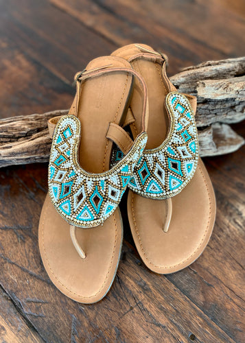 These turquoise and white beaded leather slide are a must in any wardrobe!  The design is reminiscent of the glamour of the Roman empire!   Made with soft leather with a slightly raised cushion sole and back strap to provide total comfort.  Available in sizes 37-42