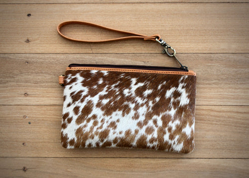 top selling clutch bag!  Made from beautiful soft cowhide on both sides, the Toronto is a perfect neat size at 20cms by 13cm, roomy enough to fit all the essentials and features a secure single zipped pocket and a single leather detachable wrist strap. 