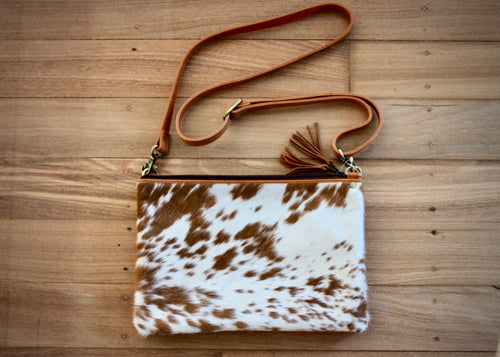beautiful soft cowhide bag is the ideal everyday handbag. Made from genuine leather,  featuring cowhide on front panel, this roomy handbag has 2 large zipped main compartments, an open pocket compartment plus a secure external zipped pocket.  Internal compartment features 5 card pockets and an open phone pocket. 