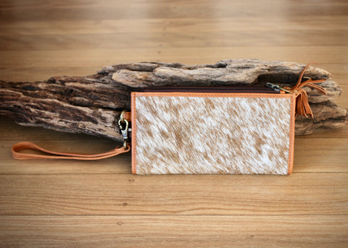 top selling cow hide wallet.  Made from beautiful soft cowhide on both sides, the Seattle is a perfect neat size, roomy enough to fit all the essentials and features a secure single zipped pockets, card holder and a single leather detachable wrist strap. 