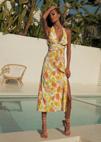 The Zola Halter Dress is a stunning, elegant dress in a beautiful Citrus floral print Rayon.  It features a super flattering midi length with a slit on one side, halterneck, and lovely folds around the fitted waist.  A fruity little number in a zesty citrus print that is sure to have heads turning.  Fully lined with an invisible zipper in the side seam and elasticated back.