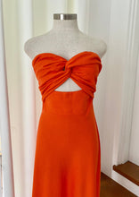 Load image into Gallery viewer, Perfect for summer days this maxi dress by Fortunate One is simply stunning in glowing orange cotton/linen.  Twisted front feature with underbust cutout, and a shirred, stretchy back pan

