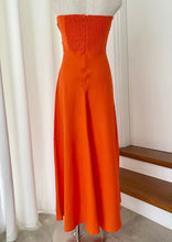 Load image into Gallery viewer, Perfect for summer days this maxi dress by Fortunate One is simply stunning in glowing orange cotton/linen.  Twisted front feature with underbust cutout, and a shirred, stretchy back pan
