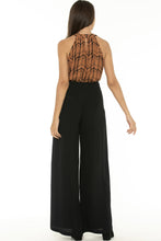 Load image into Gallery viewer, Made for effortless elegance, these Rayon Mar tailored wide leg trousers in black will take you effortlessly from desk to dinner !  Lightweight with an elegant high waist, these pants feature 2 front pockets and a flattering tailored fit.  The high waist lengthens the silhouette and the lightweight fabric is both comfortable and cool and floats elegantly with every move.  Wear with a silk blouse to the office or with an off the should top and jacket,

