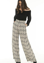 Load image into Gallery viewer, Feel effortlessly elegant in these desk to dinner Rayon Mar tailored wide leg trousers in an abstract graphic design of black/off white.  These lightweight and high waisted pants feature 2 front pockets and a flattering tailored fit.  The high waist lengthens the silhouette and the lightweight fabric floats elegantly, 
