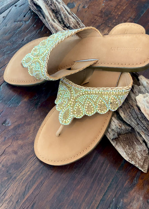 Our gold beaded all leather slide in a classic shape with contemporary detailing. These gorgeous slides can be worn day or night to add a little distinction to any ensemble.