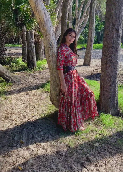 The Skye Maxi shirt dress is a gorgeous full length maxi dress, featuring a wide tiered section at the hem and side slits either side.  With a stylish shirt collar, buttoned to the chest with a seam under the bust and 3/4 cuffed sleeves. The skirt has generous volume with so much fabric, which is soft and floaty in a gorgeous red floral print.  Can be worn belted or loose with pockets