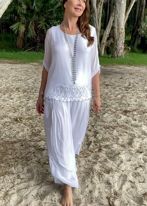 Indulge in this Summer Lace Top  by Jenny Jazz, made in Italy in luxurious 100% Italian silk/viscose with fitted cami underlay.  Loose fitting and light weight, this layered top has a pretty lace boarder detail on the cami, and drapes with soft femininity.  Romantic and elegant, this top can be worn for a special event with silk pants, a skirt or with jeans