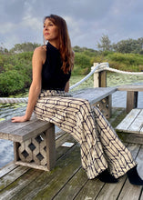 Load image into Gallery viewer, Feel effortlessly elegant in these desk to dinner Rayon Mar tailored wide leg trousers in an abstract graphic design of black/off white.  These lightweight and high waisted pants feature 2 front pockets and a flattering tailored fit.  The high waist lengthens the silhouette and the lightweight fabric is both comfortable and cool and floats elegantly with every move.

