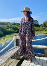 Load image into Gallery viewer, the limited edition Arcadia Elle Maxi dress is custom designed with bespoke prints by Fox&amp;Fallow. With a full skirt and a plunging frill neckline in a beautiful pale floral print against black.  It features a super flattering design with a v-neck tie front, gathered elasticized waist
