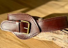 Load image into Gallery viewer, the Babushka Wide Tapered Leather Belt. Wide at the front tapering to fit through the brass buckle with a beautiful hand stamped detail. Made to be worn at the waist but can be worn on the hips (you will need to go up a size). Named after the fabulous Kate Bush song - this belt has some serious 70-80&#39;s cred!  Round brass buckle and hand stitching add to the simplicity of this gorgeously thick leather belt. 
