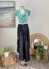 Load image into Gallery viewer, These elegant loose fitting pleated pants are versatile and very comfortable, destined to be on high rotation in your robe.  Soft tailoring in a light comfortable Viscose fabric, the Pleated Cross Over Pant are an elegant choice.  Dress them up or down to suit a social occasion, these pants are equally suitable for the office with a blouse and heals. The crossover detail at the front and soft pleats gently fall away to tulip style legs

