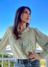 Load image into Gallery viewer, The stunning Isla Pleated blouse, beautifully made with cuffed full length sleeves, a frill neck and statement gold buttons down the front.  An abstract graphic design adorns this blouse with pleats and delicate gold elements add to the wow factor of this design.  Pair with jeans, or with tailored trousers or skirt for a more formal look.  For women who want to look elegant and effortlessly stylish from desk to dinner. 

