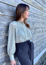 Load image into Gallery viewer, The stunning Isla Pleated blouse, beautifully made with cuffed full length sleeves, a frill neck and statement gold buttons down the front.  An abstract graphic design adorns this blouse with pleats and delicate gold elements add to the wow factor of this design.  Pair with jeans, or with tailored trousers or skirt for a more formal look.  For women who want to look elegant and effortlessly stylish from desk to dinner. 
