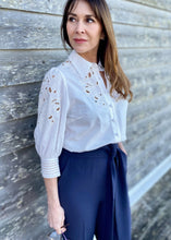 Load image into Gallery viewer, Simplicity in white! The stunning Latizia blouse by GDS comes with a fine cotton construction and embroidered detail on the sleeves and front.  The cut outs are trimmed in a soft cream cotton giving the blouse a lovely vintage tone.  Beautifully made, the 3/4 length sleeves are slightly puffed with a lovely embroidery detail and finished with exquisitely detailed cuffs, which are also buttoned.  
