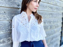 Load image into Gallery viewer, Simplicity in white! The stunning Latizia blouse by GDS comes with a fine cotton construction and embroidered detail on the sleeves and front.  The cut outs are trimmed in a soft cream cotton giving the blouse a lovely vintage tone.  Beautifully made, the 3/4 length sleeves are slightly puffed with a lovely embroidery detail and finished with exquisitely detailed cuffs, which are also buttoned.  
