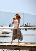 Load image into Gallery viewer, Made in Italy, from soft Italian linen, the design is both striking and uniquely elegant, with large front pockets and a full skirt with an asymmetrical hem.  The design is delightfully bohemian, and the bias cut panels drape to create movement not often seen in a linen garment.
