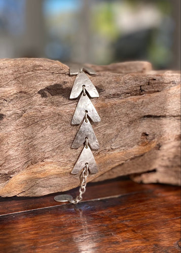   Silver plated Arrow heads create a very bohemian bracelet.  The quality silver plated pewter has a rustic finish with an adjustable hook and chain closure, one size only  * Quality silver plated pewter – lead and nickel free  * Country of Origin - Turkey  * Length: arrow head 14 section: cms (plus 4cm chain)  * Country of Origin - Turkey