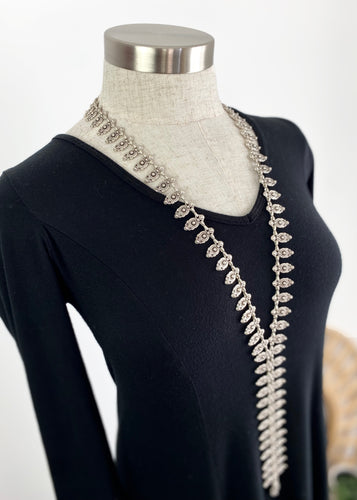 Linked Silver plated crests cascade to create a truly stunning bohemian necklace. This quality silver plated pewter necklace is a beautifully made statement piece that moves with its own weight and cascades down the body. Each individual crest is crafted with an intricate pattern to create a stunning piece that will finish any outfit, especially a simple dress or your favourite jeans.  One size only  * Quality silver plated pewter – lead and nickel free  * Country of Origin - Turkey  * Length: 60cms