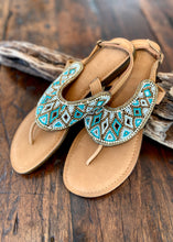 Load image into Gallery viewer, These turquoise and white beaded leather slide are a must in any wardrobe!  The design is reminiscent of the glamour of the Roman empire!   Made with soft leather with a slightly raised cushion sole and back strap to provide total comfort.  Available in sizes 37-42
