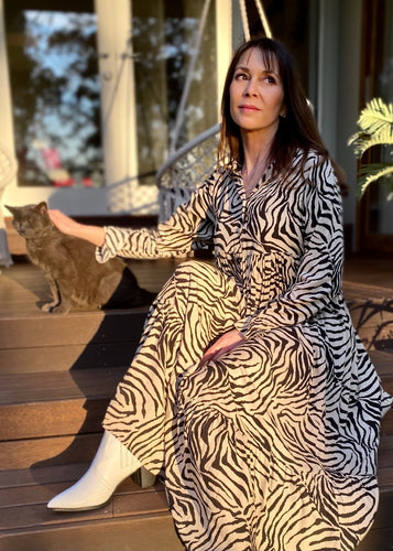 The Audrey dress is a lesson in edgy femininity with soft lines in a bold print.  Maxi length with full length sleeves and ruffle sleeve detail, with a collar and button down to the empire waist line.  Crafted from soft 100% Rayon, in a gorgeous zebra style print in black against cream, it really will be a long term favourite.