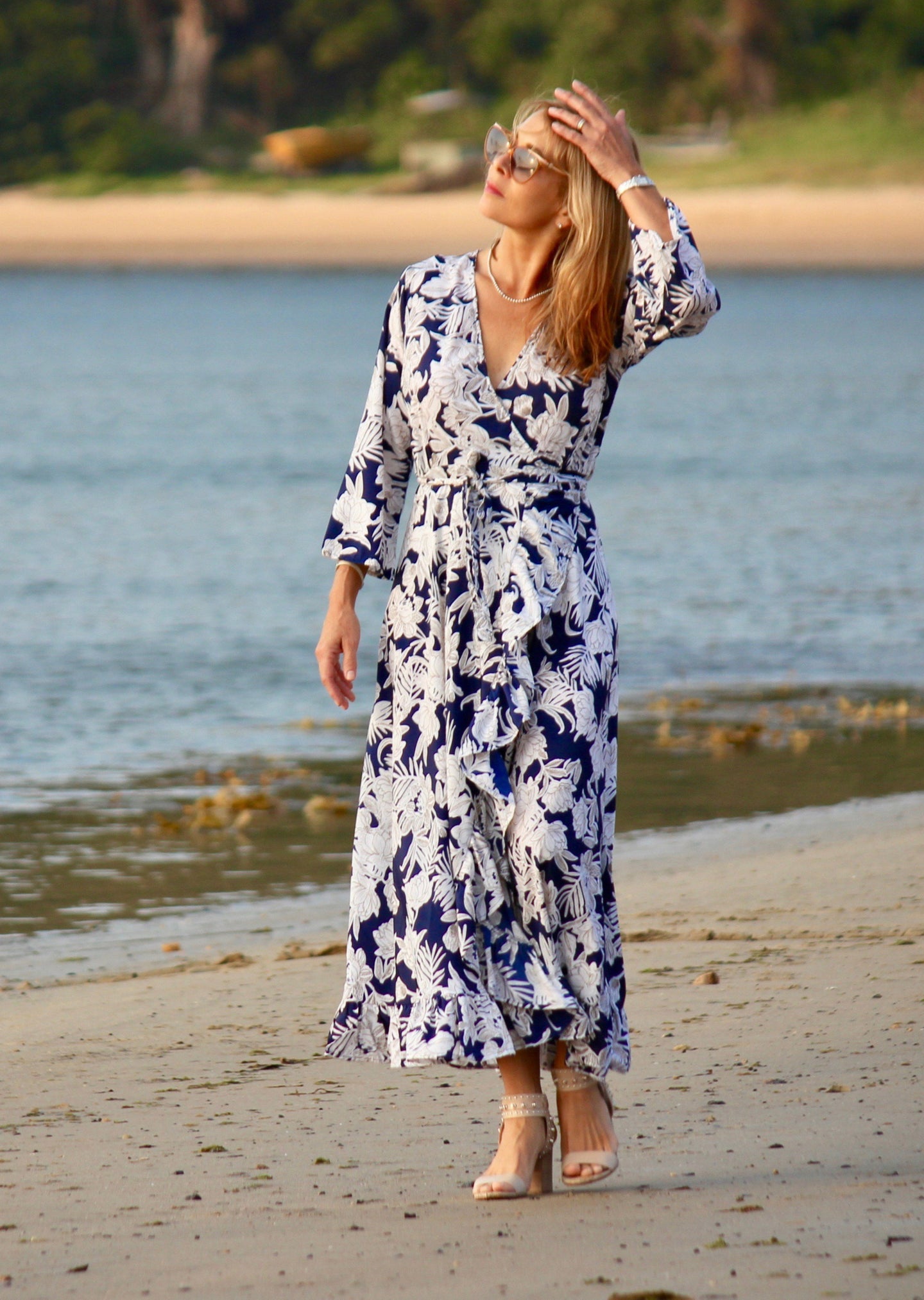 The Destiny Dress is a timeless wrap style which wraps around and ties at the side to separate the bust and reduce the hips and waist.  Perfect for those of us with curves, the long flowing skirt flatters the figure and creates a gorgeous hour-glass shape.  The navy and white floral print is striking and the silk blend fabric is lightweight and cool making this the perfect dress for a wedding, a dinner, a lunch.