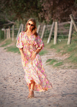 Load image into Gallery viewer, The Beatrice Dress -  the long loose flowing skirt lightly skims the body flattering the figure.  The silk blend fabric is lightweight and cool. The skirt is split at the sides to the knee and the V neckline crosses the bust with a drawstring tie under the bust, creating a flattering silhouette.  Finished with wide short bell sleeves, you will feel utterly feminine in the pretty floral print. 
