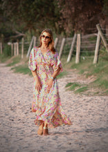 Load image into Gallery viewer, The Beatrice Dress -  the long loose flowing skirt lightly skims the body flattering the figure.  The silk blend fabric is lightweight and cool. The skirt is split at the sides to the knee and the V neckline crosses the bust with a drawstring tie under the bust, creating a flattering silhouette.  Finished with wide short bell sleeves, you will feel utterly feminine in the pretty floral print. 
