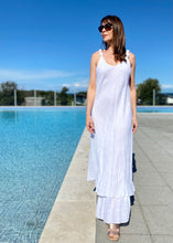 Load image into Gallery viewer, The Koko Maxi dress is a gorgeous full length pure white Italian linen dress, featuring a delicate layered hemline, and a slender but relaxed design that falls beautifully over the body to create an elegant silhouette.  The exquisite Italian linen is both cool and comfortable with gathered detail straps that are both pretty and of course hide the straps of any under-garments
