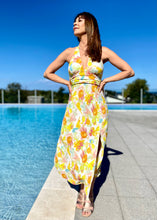 Load image into Gallery viewer, The Zola Halter Dress is a stunning, elegant dress in a beautiful Citrus floral print Rayon.  It features a super flattering midi length with a slit on one side, halterneck, and lovely folds around the fitted waist.  A fruity little number in a zesty citrus print that is sure to have heads turning.  Fully lined with an invisible zipper in the side seam and elasticated back.
