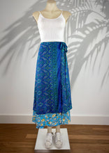Load image into Gallery viewer, The gorgeous Goddess silk blend wrap skirts by Cienna designs, in a stunning sapphire blue and emerald pattern, with a turquoise and yellow patterned second layer.  These skirts are reversible so choose the pattern that suits your mood!   Can also be worn as a dress 
