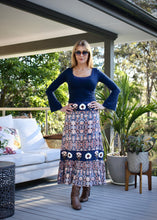 Load image into Gallery viewer, Inspired by beautiful Moroccan tiles, the ankle length Clara Skirt is made from a quality Indian cotton and features an exquisite embroidered navy panel around the hips and at mid length.  The embroidery is embellished with beading and buttons, and tiered with an exotic patterned fabric in a vibrant orange and blue to make for a really stunning skirt.
