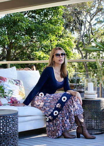 Inspired by beautiful Moroccan tiles, the ankle length Clara Skirt is made from a quality Indian cotton and features an exquisite embroidered navy panel around the hips and at mid length.  The embroidery is embellished with beading and buttons, and tiered with an exotic patterned fabric in a vibrant orange and blue to make for a really stunning skirt.