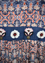 Load image into Gallery viewer, Inspired by beautiful Moroccan tiles, the ankle length Clara Skirt is made from a quality Indian cotton and features an exquisite embroidered navy panel around the hips and at mid length.  The embroidery is embellished with beading and buttons, and tiered with an exotic patterned fabric in a vibrant orange and blue to make for a really stunning skirt.
