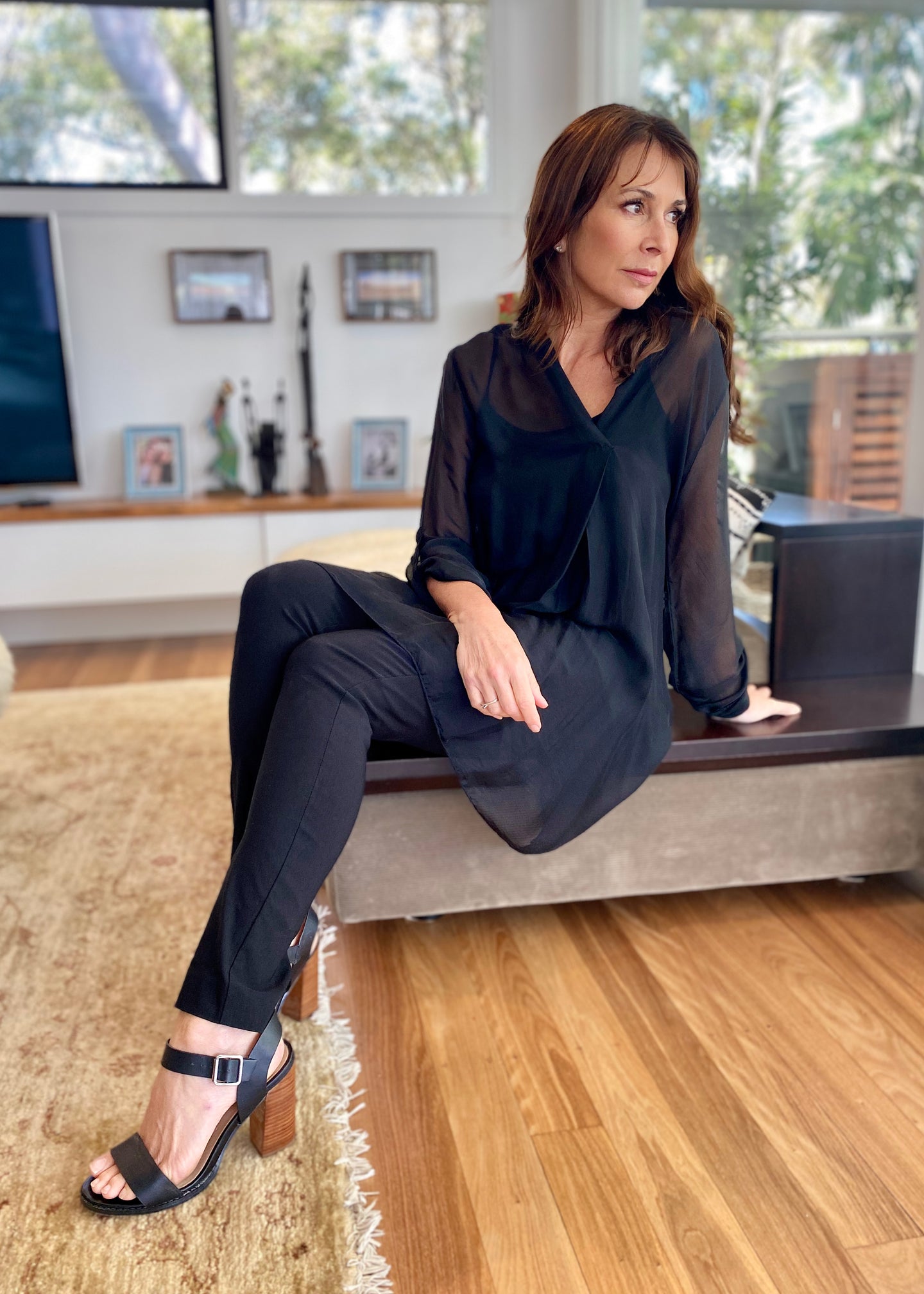 The April Long Top by Jenny Jazz has been designed for relaxed sophistication and is every bit chic as it is gorgeously feminine. Made in Italy, this delicate and sheer silk blend top has a combined soft viscose camisole to keep you covered  It has a V neck and soft pleat down the front, and the sheer sleeves can be worn partly rolled up and secured with a single buttoned.  Finishing just above the knee it floats with your every movement and is perfect to wear with silk pants, leggings or jeans.