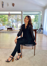 Load image into Gallery viewer, The April Long Top by Jenny Jazz has been designed for relaxed sophistication and is every bit chic as it is gorgeously feminine. Made in Italy, this delicate and sheer silk blend top has a combined soft viscose camisole to keep you covered  It has a V neck and soft pleat down the front, and the sheer sleeves can be worn partly rolled up and secured with a single buttoned.  Finishing just above the knee it floats with your every movement and is perfect to wear with silk pants, leggings or jeans.
