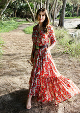 Load image into Gallery viewer, The Skye Maxi shirt dress is a gorgeous full length maxi dress, featuring a wide tiered section at the hem and side slits either side.  With a stylish shirt collar, buttoned to the chest with a seam under the bust and 3/4 cuffed sleeves. The skirt has generous volume with so much fabric, which is soft and floaty in a gorgeous red floral print.  Can be worn belted or loose with pockets
