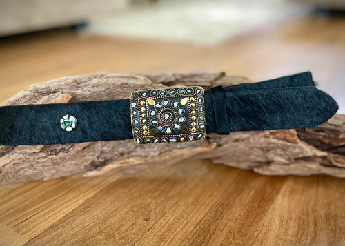 Real cow hide leather belt in rich black hide with an ornate metal buckle with beautiful detailed Mother of Pearl and Brass inlay.   Delicate metal buttons inlaid with Mother of Pearl, Brass and Turquoise are featured along the belt.  Can be worn loose or fitted