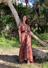 Load image into Gallery viewer, The Skye Maxi shirt dress is a gorgeous full length maxi dress, featuring a wide tiered section at the hem and side slits either side.  With a stylish shirt collar, buttoned to the chest with a seam under the bust and 3/4 cuffed sleeves. The skirt has generous volume with so much fabric, which is soft and floaty in a gorgeous red floral print.  Can be worn belted or loose with pockets
