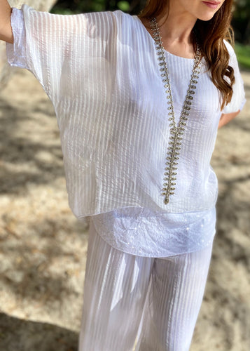 Feel both feminine and glamorous in the Primadonna Shimmer Top in white on white stripe!  Made in Italy, this gorgeous silk and sequined top is light weight and layered with a fitted cami under.  The sheer short sleeves are highlighted with sequins and the fitted cami also has a wide sequin band at the hip, adding a layer of stunning sparkle!  