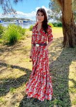 Load image into Gallery viewer, The Skye Maxi shirt dress is a gorgeous full length maxi dress, featuring a wide tiered section at the hem and side slits either side.  With a stylish shirt collar, buttoned to the chest with a seam under the bust and 3/4 cuffed sleeves. The skirt has generous volume with so much fabric, which is soft and floaty in a gorgeous red floral print.  Can be worn belted or loose with pockets
