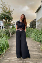 Load image into Gallery viewer, Kanzzi Pants are made for effortless elegance. these Rayon Mar tailored wide leg trousers in black will take you effortlessly from desk to dinner !  Lightweight with an elegant high waist, these pants feature 2 front pockets and a flattering tailored fit.  The high waist lengthens the silhouette and the lightweight fabric is both comfortable and cool and floats elegantly with every move
