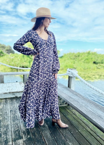 The Elle Maxi is  Perfect for any social occasion, and great for work.  Wih a full skirt and a plunging frill neckline in a beautiful soft pink, beige and aubergine floral print against black.  It features a super flattering design with a v-neck front, empire waist, 3 tiered ruffled hem, a side zip and elegant bell sleeves.  In a gorgeous soft Rayon, it is breast-feeding friendly with buttons at the front and is super quick and easy