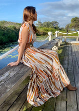 Load image into Gallery viewer, The Emily Dress by Caro, in a gorgeous print of earthy tones that represent the colours of outback Australia. The soft 100% Rayon fabric is lightweight and cool, and the loose flowing skirt has a pretty oversized tier.  it is buttoned down the front so can be worn open layered over shorts, jeans or buttoned up as a dress.  Delicate cap sleeves, a gathered waist and a V neckline create a flattering silhouette, and pockets give it a relaxed feel. 
