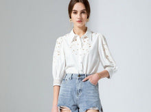 Load image into Gallery viewer, Simplicity in white! The stunning Latizia blouse by GDS comes with a fine cotton construction and embroidered detail on the sleeves and front.  The cut outs are trimmed in a soft cream cotton giving the blouse a lovely vintage tone.  Beautifully made, the 3/4 length sleeves are slightly puffed with a lovely embroidery detail and finished with exquisitely detailed cuffs, which are also buttoned.  
