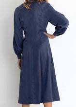 Load image into Gallery viewer, Another stunning and luxurious dress by GDS, the Aiden Tie Waist Dress is crafted of a rich Tencel/linen blend, a mid-weight fabric with a beautiful soft sheen and touch. Featuring an adjustable corset inspired string tie at the front which creates an exceptionally flattering shape.  The fabric falls beautifully with soft, graceful movement.  With a sophisticated mandarin collar, hidden buttons and soft pleats at the front, this beautifully tailored dress is designed to create a gorgeous silhouette.
