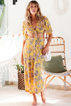 Load image into Gallery viewer, Our Bonni Pants are the cutest addition to your summer wardrobe, a total ray of sunshine, made for days with endless blue skies.  These high-waisted, wide legs pants in a bright yellow floral print with a zip enclosure at the back and 2 soft pleats at the front.  Full of summer sunshine and utterly flattering, these culotte style pants will take you from the beach during the day to a wine bar at night. 
