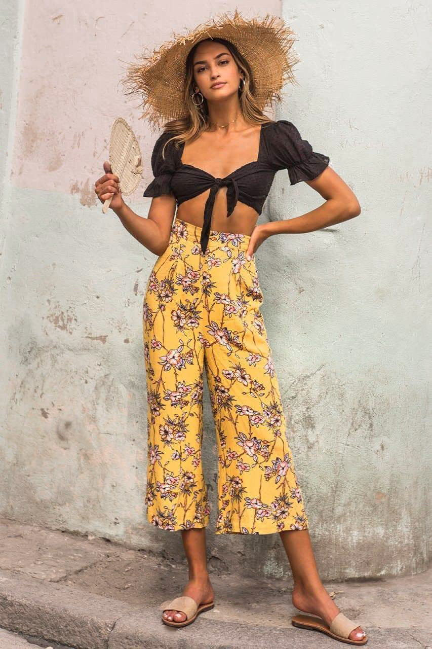Our Bonni Pants are the cutest addition to your summer wardrobe, a total ray of sunshine, made for days with endless blue skies.  These high-waisted, wide legs pants in a bright yellow floral print with a zip enclosure at the back and 2 soft pleats at the front.  Full of summer sunshine and utterly flattering, these culotte style pants will take you from the beach during the day to a wine bar at night. 