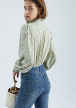 Load image into Gallery viewer, The stunning Isla Pleated blouse, beautifully made with cuffed full length sleeves, a frill neck and statement gold buttons down the front.  An abstract graphic design adorns this blouse with pleats and delicate gold elements add to the wow factor of this design.  Pair with jeans, or with tailored trousers or skirt for a more formal look.  For women who want to look elegant and effortlessly stylish from desk to dinner. 

