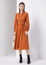 Load image into Gallery viewer, Another stunning and luxurious dress by GDS, the Aiden Tie Waist Dress is crafted of a rich Tencel/linen blend, a mid-weight fabric with a beautiful soft sheen and touch. Featuring an adjustable corset inspired string tie at the front which creates an exceptionally flattering shape.  The fabric falls beautifully with soft, graceful movement.  With a sophisticated mandarin collar, hidden buttons and soft pleats at the front, this beautifully tailored dress is designed to create a gorgeous silhouette.
